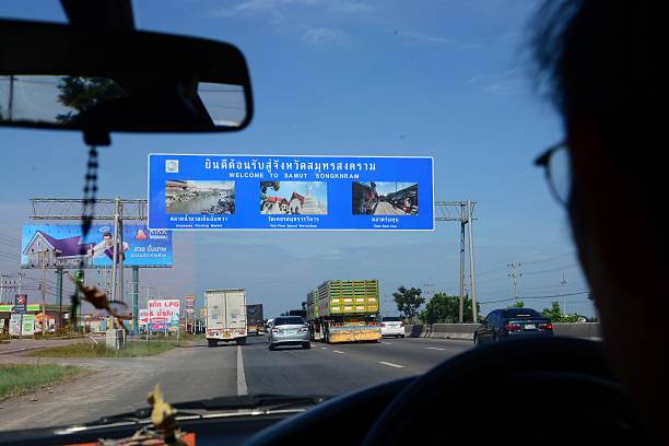 Welcome to Samut Songchram Samut Songchram,Thailand - June 29, 2014 : Highways in Samutsongkhram.One Man driving Samutsongkhram. wikipedia stock pictures, royalty-free photos & images
