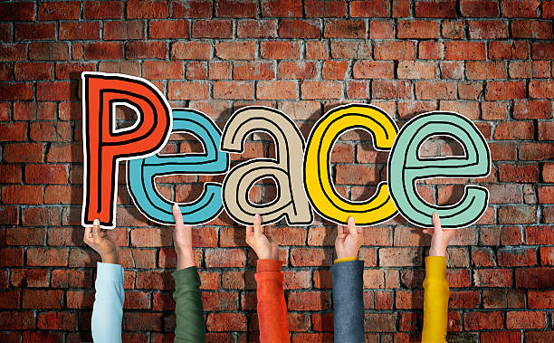 istock Group of Diverse People's Hands Holding Word Peace 514655055