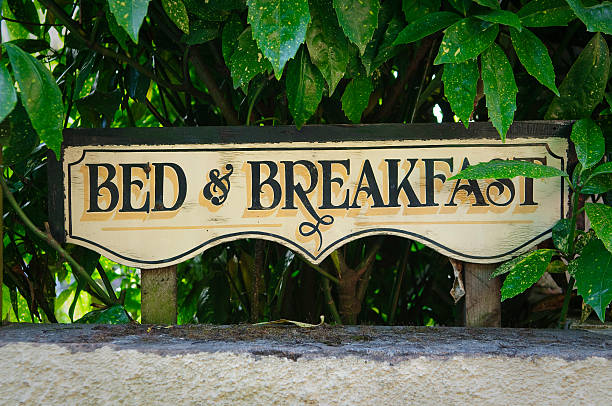 Bed and breakfast vintage sign Bed and breakfast vintage sign on fence. Devon, UK. bed and breakfast stock pictures, royalty-free photos & images