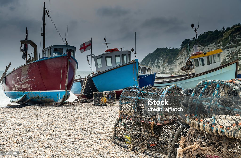Fishing boats on Beer Beach, Dorset Fishing boats and lobster pots on Beer Beach, Dorset, England Beach Stock Photo