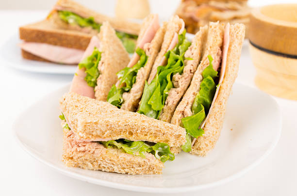 istock ham and lettuce sandwich on a white plate 514658385