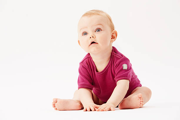 istock Baby girl looking up against white background 514671111