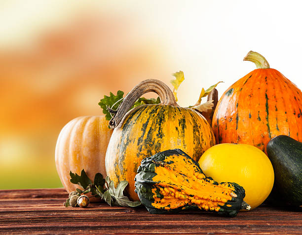 istock Autumn colored pumpkins on wooden table 514673977