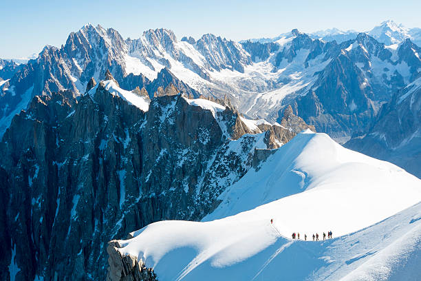Mont Blanc mountaineers Mont Blanc mountaneers walking on snowy ridge. The mountain is the highest in the alps and the European Union. mont blanc photos stock pictures, royalty-free photos & images