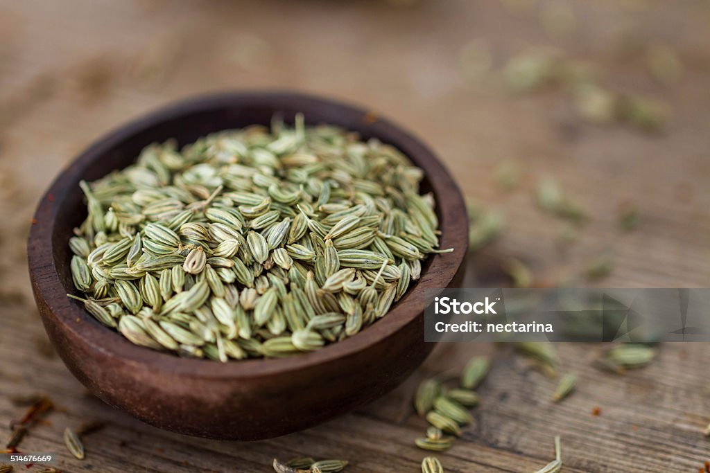 Fennel seeds Fennel seeds in a small wooden bowl on an old wooden table. Backgrounds Stock Photo