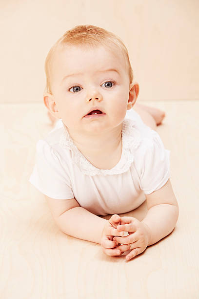 istock Baby girl looking up, studio shot 514676783