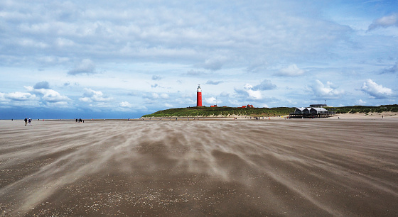 Beach and dunes with lighthouse. Picture is taken at the North Cape on the Wadden Island Texel in the Netherlands.The wadden islands of the Netherlands are listed by Unesco heritage.