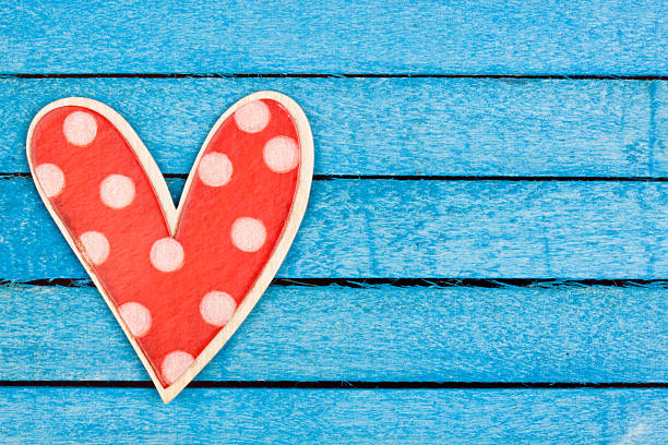 polka dot wooden heart shape on a blue background