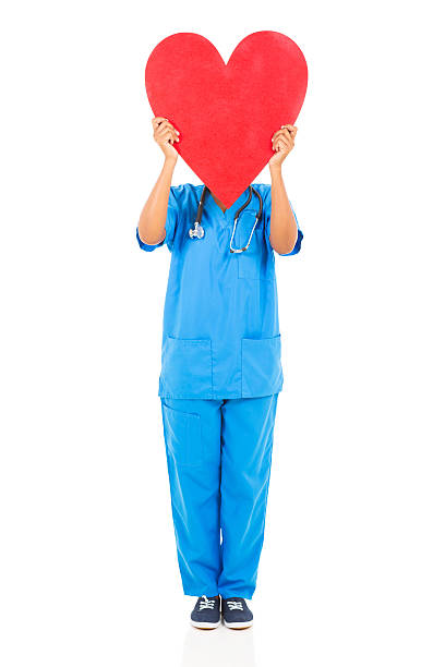 istock african nurse hiding her face behind heart shape 514688401