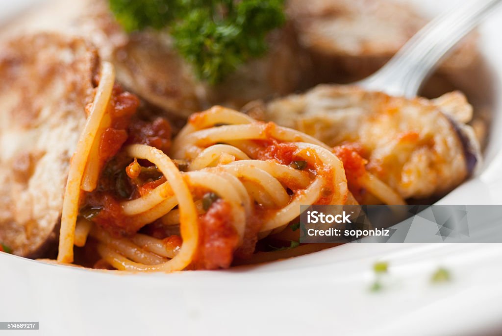 Spaghetti with a slice of grilled eggplant Spaghetti with a slice of grilled eggplant served on a white plate Backgrounds Stock Photo