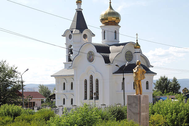 Under blue sky, Lenin staying up an Orthodox Church in Siberia.