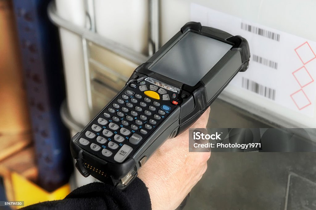 Person scanning a barcode with a scanner Person scanning a barcode with a handheld electronic scanner to identify a retail product or inventory and access the price and information on a digital readout Bar Code Reader Stock Photo