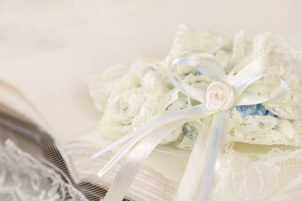 istock Wedding garter on a white book or album 514715014