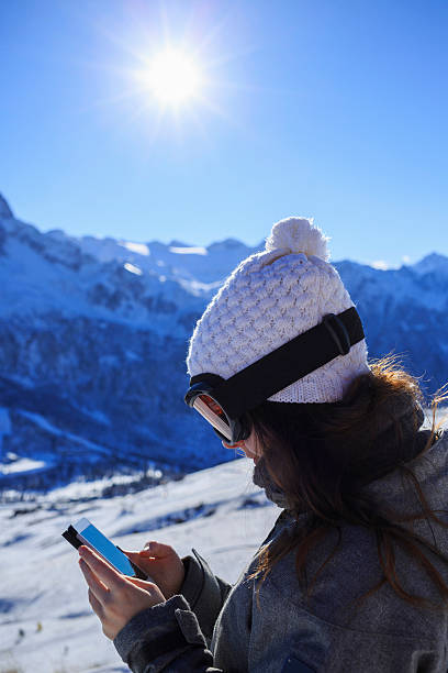 istock Snow skier young woman using a smartphone  Alps mountain 514715166