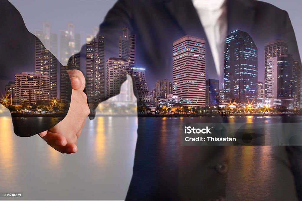 Double exposure of handshake night city, urban and lake Backgrounds Stock Photo
