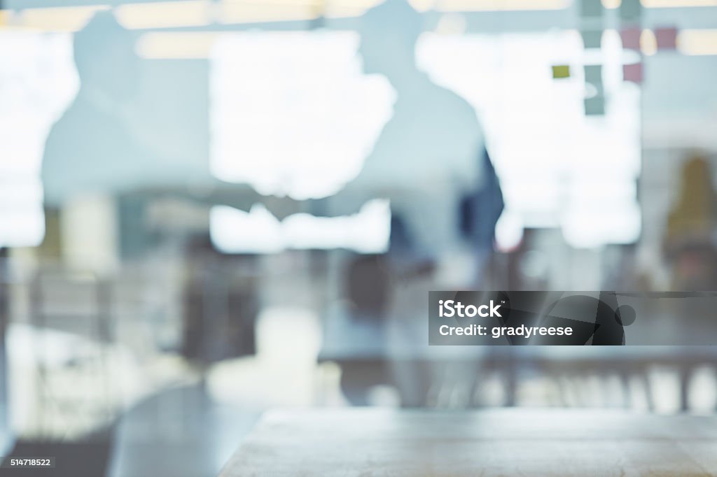 Behind the screen of corporate success Through the glass shot of a people working in an office Abstract Stock Photo