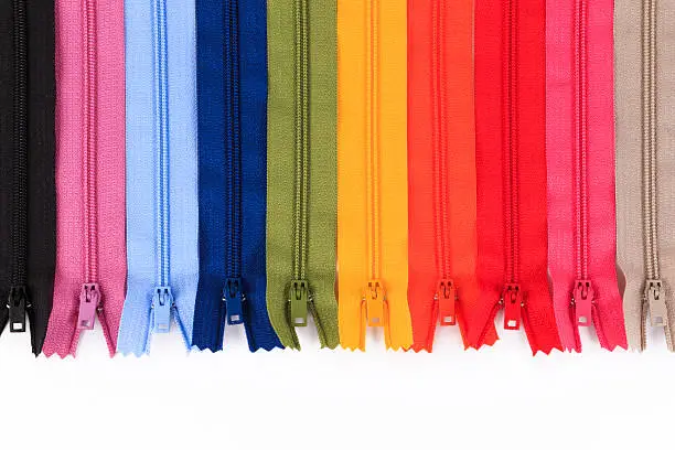 Photo of Colorful Zippers in different colors on white background.