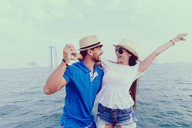 Vintage retro couple, man and woman enjoying their romantic date outside wearing fedora hats.