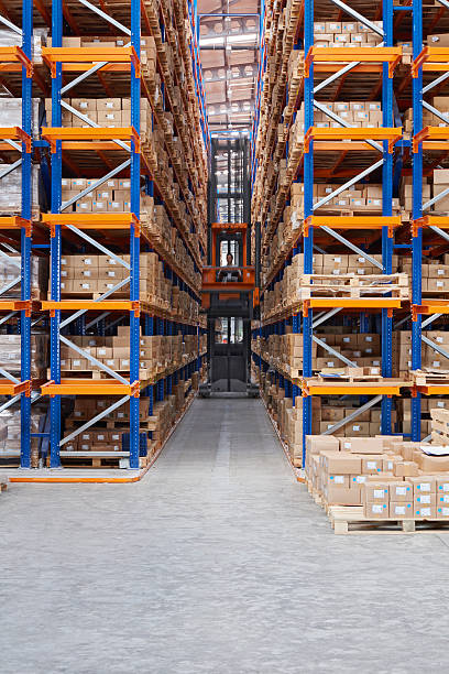 istock Front view of a man driving a forklift in aisle 514720490