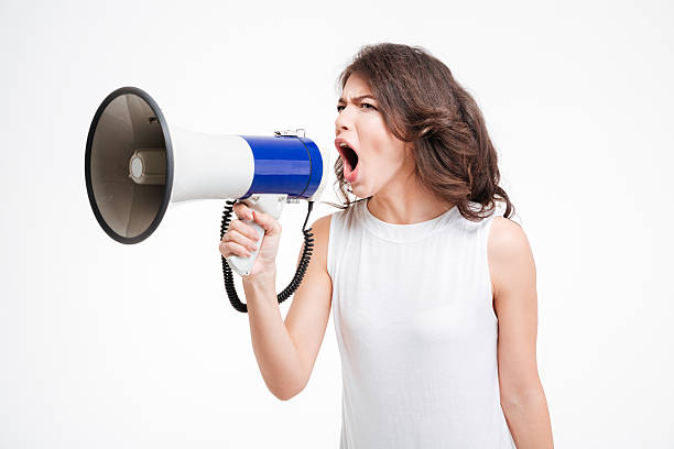 istock Young woman shouting into loudspeaker 514721432