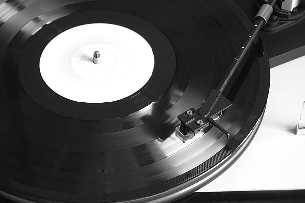 istock Turntable with playing vinyl record closeup 514725490