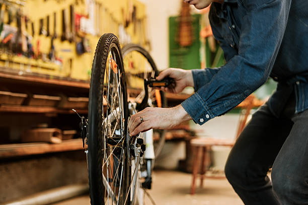 istock Man preparing bicycle for spring in his garage 514726212