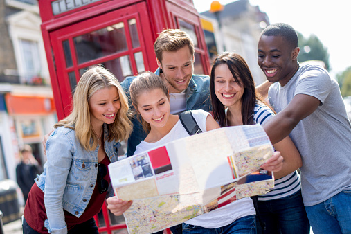 Group of tourists sightseeing in London with a map