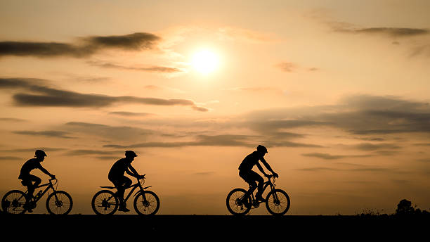 istock Silhouette of cyclist with friend motion on sunset background 514728068