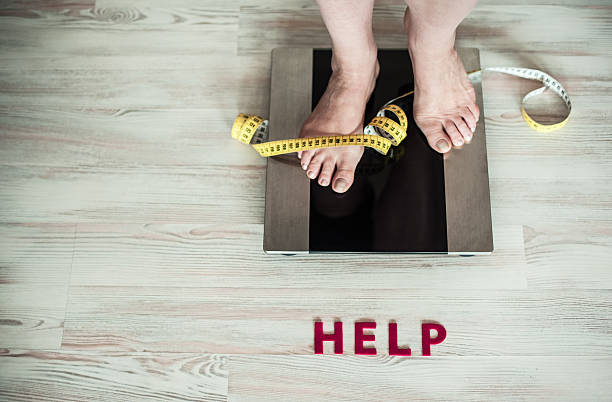 Feet on weight scale stock photo