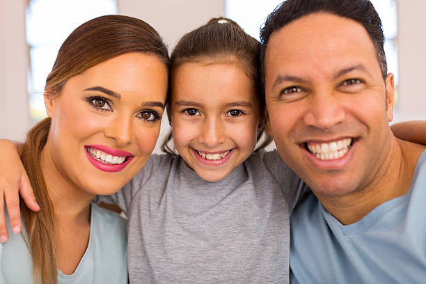 istock little girl hugging her parents 514729038