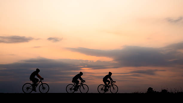 istock Silhouette of cyclist with friend motion on sunset background 514729236