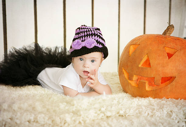 istock little girl with Down Syndrome finger 514729759