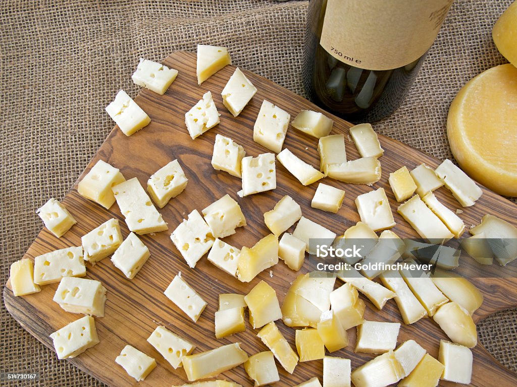 Cheese pieces and wine tasting. On rustic hessian. Genuine. Bottle Stock Photo