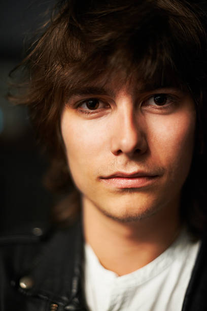 Pensive Young Man Portrait on the Blue Background