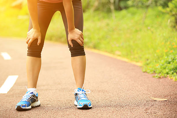 istock tired woman runner  have a rest after running hard 514730667