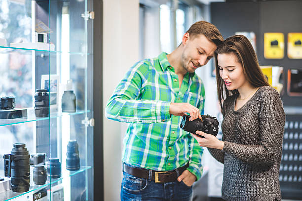 istock Customers examining SLR camera in the store 514730964