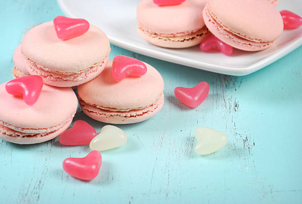 istock Pink macarons with pink and white jelly candy hearts 514731307