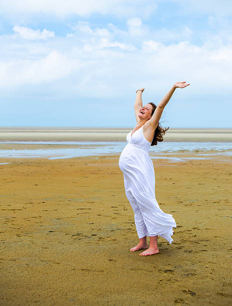 istock Joyful Pregnant Woman on the Beach 514731695