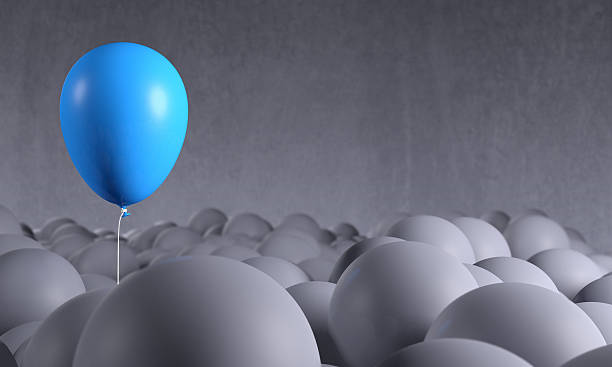 istock Blue balloon rising from gray background: individuality, standing out 514732296