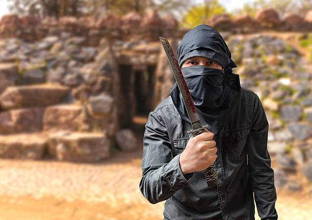 istock Terrorist threatening with bloody blade. Terrorism concept. 514732866