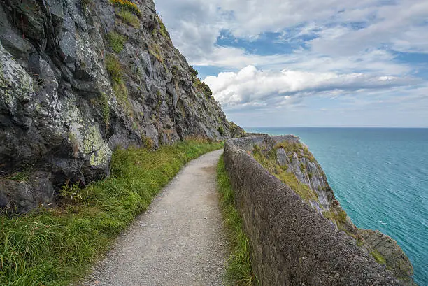 Photo of Stone rocks mountain path at Irish seacoast. Bray, Greystone