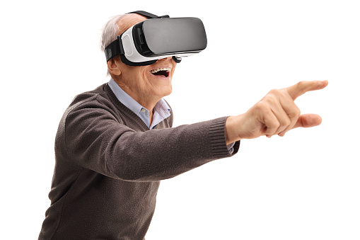 Senior man using a VR headset and reaching with his hand isolated on white background