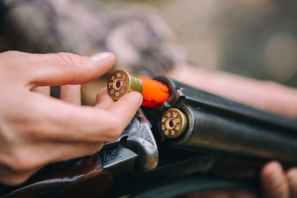 männliche jäger im wald - rifle bullet war sport stock-fotos und bilder