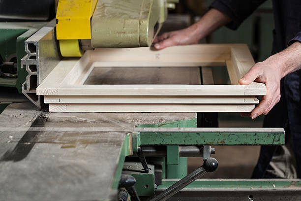 istock Carpenter's hands cutting wooden window frame 514739910