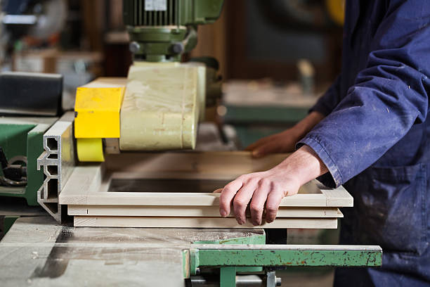 istock Carpenter's hands cutting wooden window frame 514740342