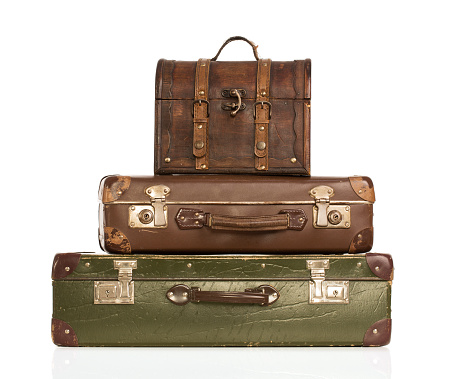 Stack of vintage suitcases isolated on white background