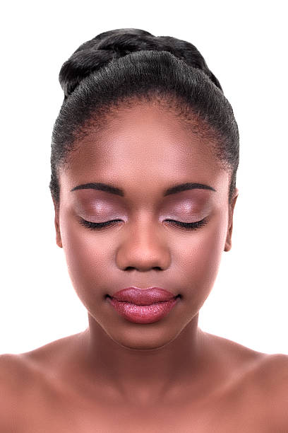 Woman with beautiful skin Beautiful African woman with fresh clean skin and everyday natural face makeup on white. Skin care and spa. black woman hair bun stock pictures, royalty-free photos & images