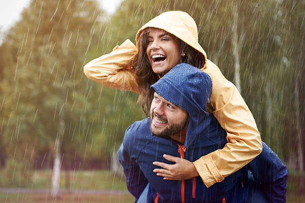 Happy time despite bad weather Happy time despite bad weather hood clothing stock pictures, royalty-free photos & images