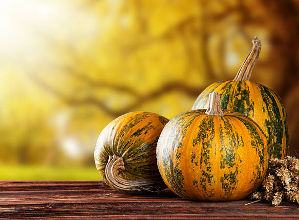 istock Autumn colored pumpkins on wooden table 514755679