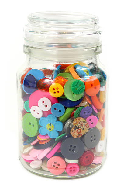 Colorful Haberdashery buttons in a glass jar. stock photo